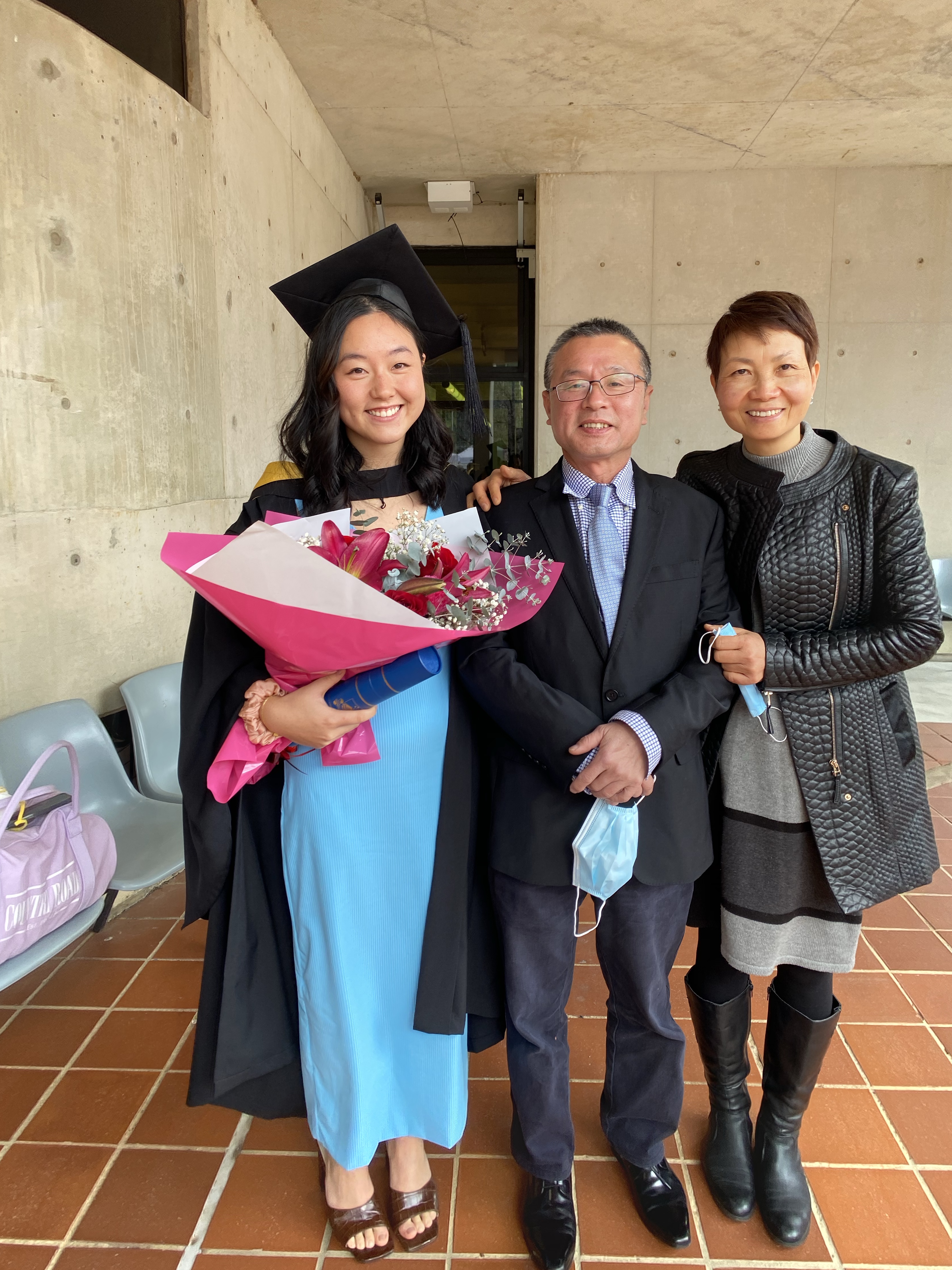 Jade with her parents at graduation